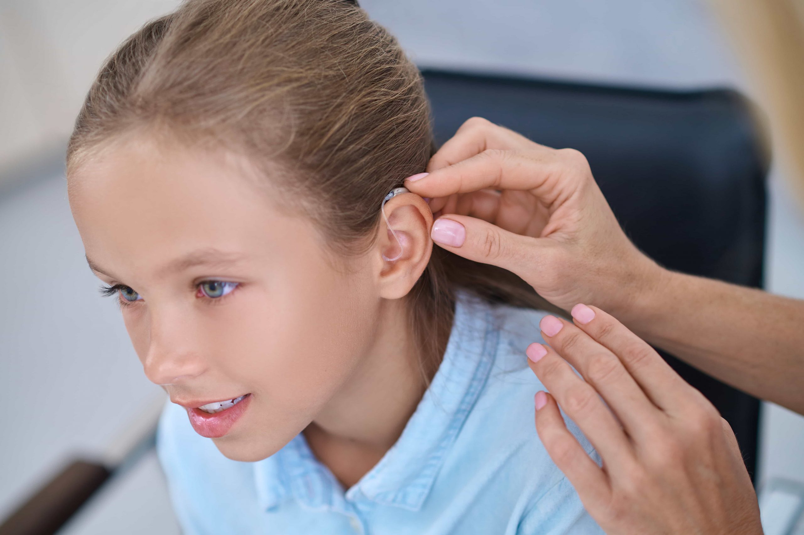 female-patient-having-hearing-device-attached-her-ear