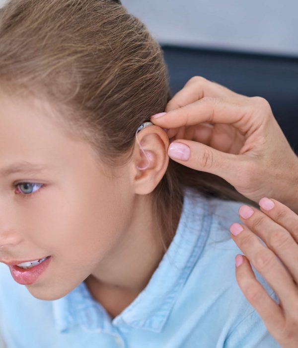 female-patient-having-hearing-device-attached-her-ear